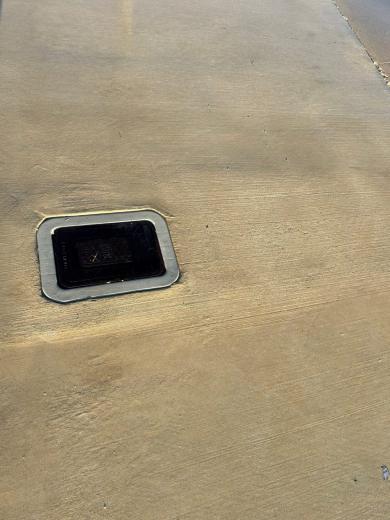 Concrete slab around a drain, mid-wash